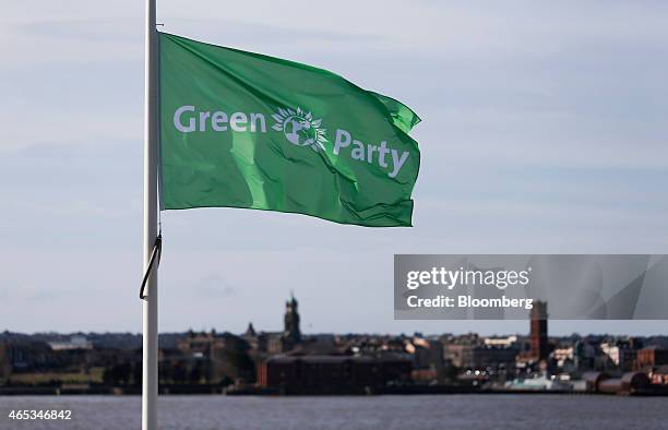 The Green Party logo sits on a flag as it flies beside the River Mersey during the party's spring conference in Liverpool, U.K., on Friday, March 6,...