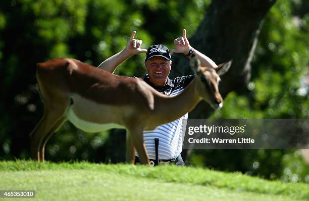 Doug McGuigan of South Africa poses behind a deer on the 14th hole during the second round of the Africa Open at East London Golf Club on March 6,...