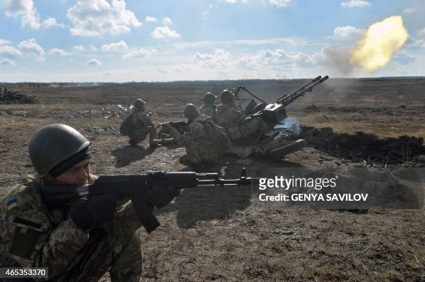 Ukrainian paratroopers take part in military drills in the Zhytomyr region, some 150 kms from Kiev, on March 6, 2015. Western powers said new...