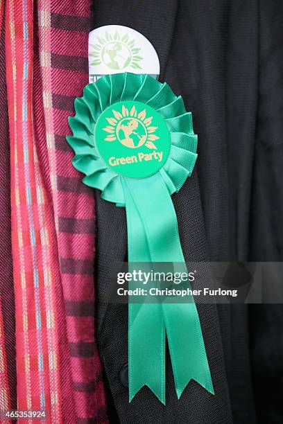 Delegate wears a party rosette during the Green Party spring conference at the Arena Convention Centre on March 6, 2015 in Liverpool, England. During...