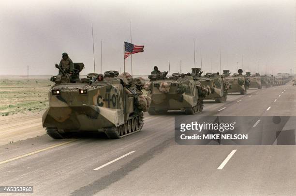 Photo taken 05 March 1991 of a convoy of US Army tanks driving down the road from Kuwait towards Dhahran in the Saudi desert as US troops begin their...
