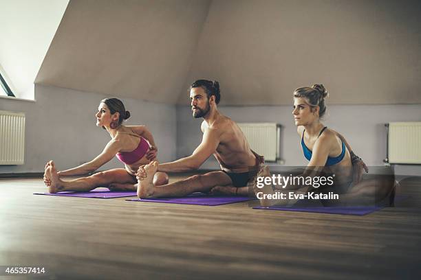 young people exercising yoga - hot yoga stock pictures, royalty-free photos & images