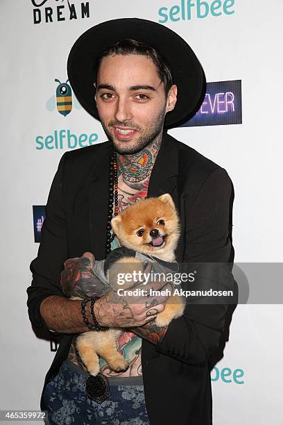 Tattoo artist Romeo Lacoste and Jiff the Dog attend the California Dream Grand Opening Event & Experience at The California Dream on March 5, 2015 in...