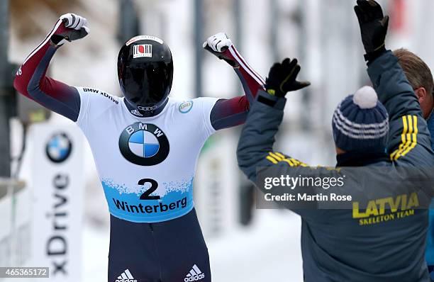 Tomass Dukurs of Latvia celebrates after his fourth run of the men's skeleton competition during the FIBT Bob & Skeleton World Cup at Bobbahn...