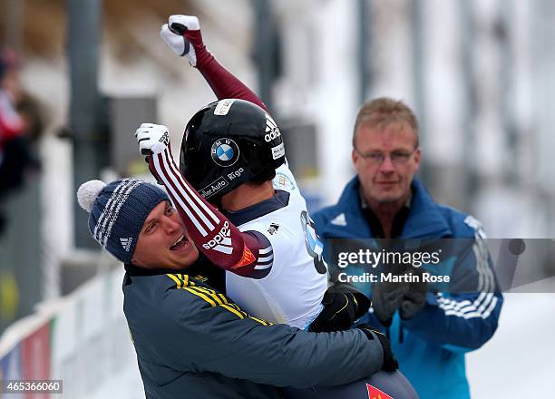 Tomass Dukurs of Latvia celebrates after his fourth run of the men's skeleton competition during the FIBT Bob & Skeleton World Cup at Bobbahn...