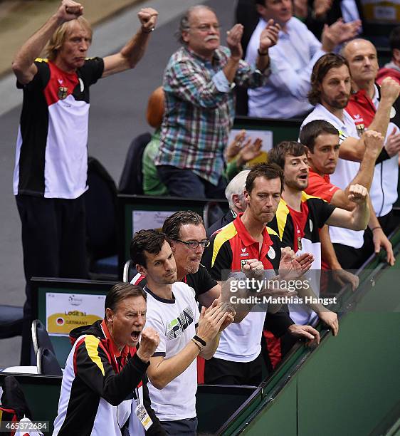 Consultant Niki Pilic of Germany and fitness and mental coach Carlo Thraenhardt of Germany celebrate during day one of the Davis Cup World Group...