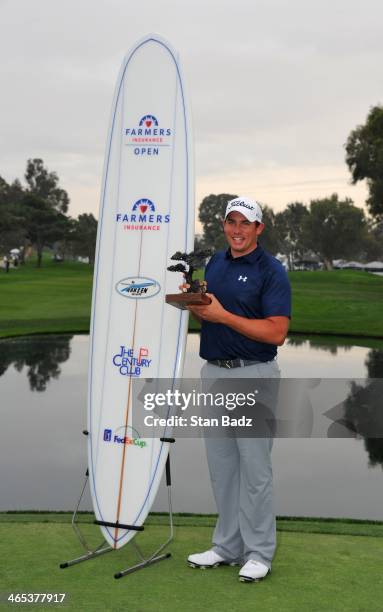 Scott Stallings poses with the winner's trophy and a surfboard after winning the Farmers Insurance Open at Torrey Pines Golf Course on January 26,...