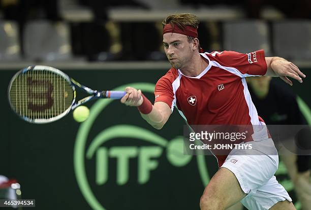 Switzerland's Michael Lammer returns the ball to Belgium's Steve Darcis during their tennis match at the Davis Cup World Group first round between...