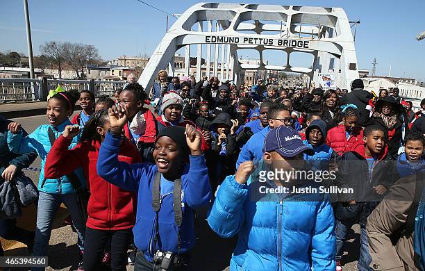 School kids walk across the Edmund Pettus Bridge as they visit historic sites from the Selma to Montgomery civil rights march on March 6, 2015 in...