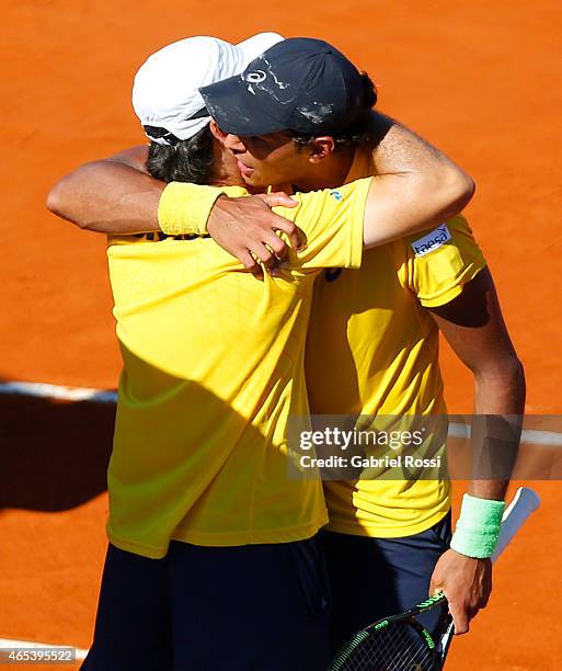 Joao Souza of Brazil celebrates with Joao Zwetsch coach of Brazil after wining the singles match between Carlos Berlocq of Argentina and Joao Souza...