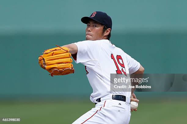 Koji Uehara of the Boston Red Sox warms up before pitching the third inning of the game against the Miami Marlins at Jet Blue Park on March 6, 2015...