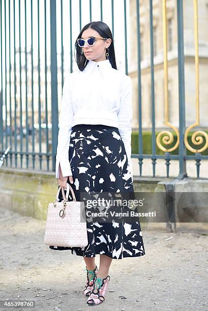 Marta Pozzan poses wearing an Audra shirt, Dior bag, Banana Republic skirt and Sophie Webster shoes on Day 4 of Paris Fashion Week Womenswear FW15 on...