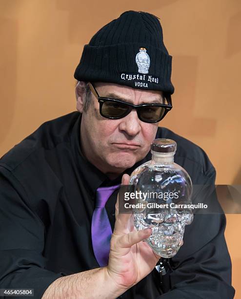 Actor Dan Aykroyd signs bottles of Crystal Head Vodka during 186th PHS Philadelphia Flower Show, 'Celebrate the Movies', at Pennsylvania Convention...