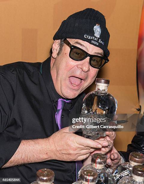 Actor Dan Aykroyd signs bottles of Crystal Head Vodka during 186th PHS Philadelphia Flower Show, 'Celebrate the Movies', at Pennsylvania Convention...