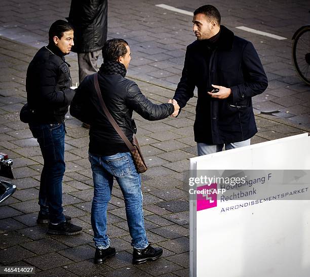 Former Dutch-Moroccan K-1 heavyweight kick-boxing champion Badr Hari is greeted by fans as he arrives at a courthouse in Amsterdam, Netherlands, on...