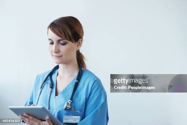 diagnosing patients using digital tools - peopleimages hospital stock pictures, royalty-free photos & images