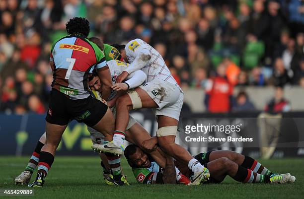 Terrence Hepetema of Leicester Tigers is tackled by Jordan Turner-Hall and Maurie Fa'asavalu of Harlequins during the LV= Cup match between...
