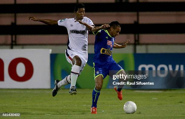 Cesar Pereyra of Sporting Cristal struggles for the ball with Jose Canova of San Martin during a match between San Martin and Sporting Cristal as...