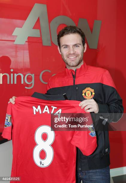 Juan Mata of Manchester United poses with his number 8 shirt ahead of the press conference to announce his signing at Aon Training Complex on January...