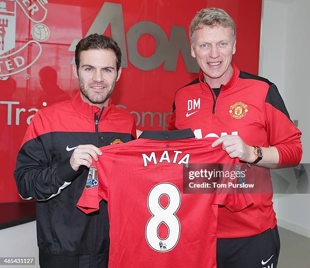 Juan Mata of Manchester United poses with his number 8 shirt ahead of the press conference to announce his signing at Aon Training Complex on January...