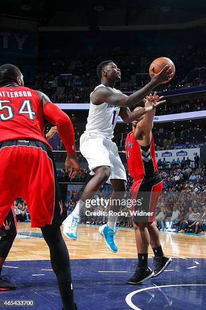 Lance Stephenson of the Charlotte Hornets shoots a layup against Chuck Hayes of the Toronto Raptors on March 6, 2015 at Time Warner Cable Arena in...