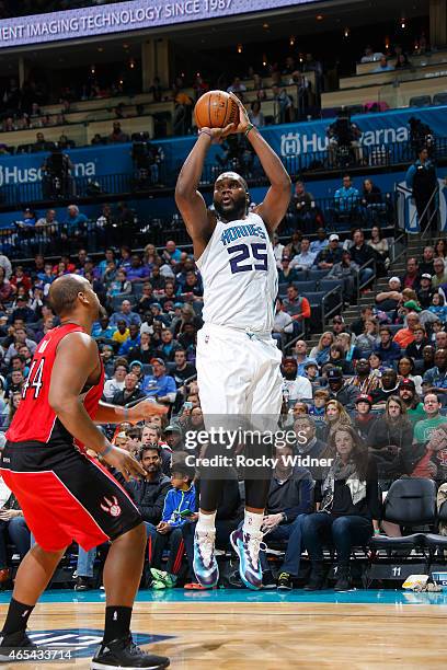 Al Jefferson of the Charlotte Hornets shoots against Chuck Hayes of the Toronto Raptors on March 6, 2015 at Time Warner Cable Arena in Charlotte,...