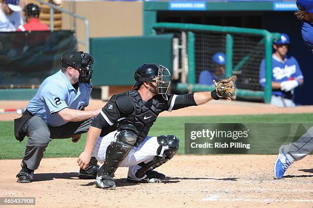 George Kottaras of the Chicago White Sox catches during the game against the Los Angeles Dodgers on March 5, 2015 at Camelback Ranch-Glendale in...