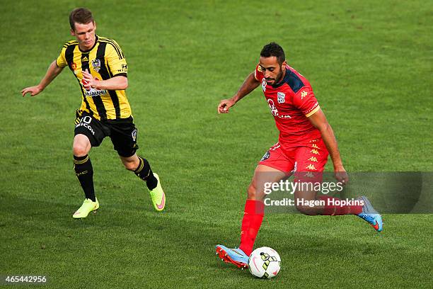 Tarek Elrich of Adelaide United runs the ball under pressure from Michael McGlinchey of the Phoenix during the round 20 A-League match between the...