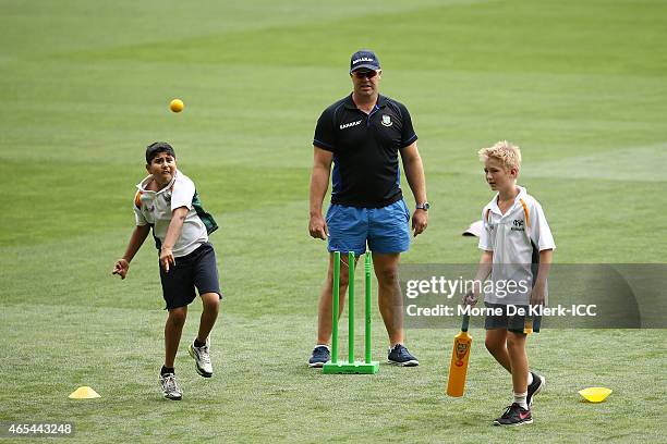 Bangladesh bowling coach Heath Streak looks on as kids from the Woodville Rechabite Cricket Club bat and bowl during the ICC Charity Coaching Clinic...