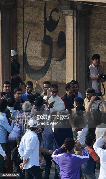 Indian Bollywood film actor Amitabh Bachchan waves to fans as he leaves the ancient Jama Masjid in Ahmedabad on Janaury 27, 2014. Bachchan came to...