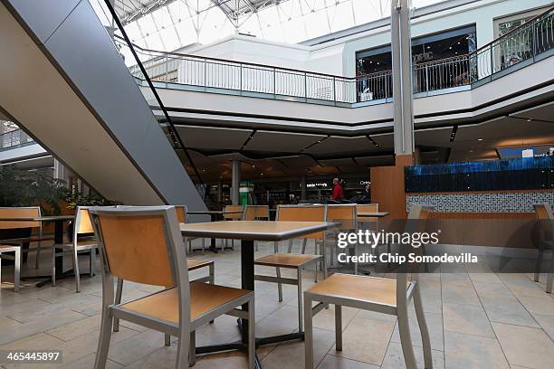 Just above the food court, the Zumiez store where two days earlier three people were shot and killed is now boarded up at the Mall in Columbia...