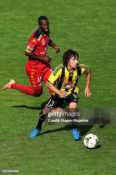 Albert Riera of the Phoenix makes a break from Bruce Djite of Adelaide United during the round 20 A-League match between the Wellington Phoenix and...