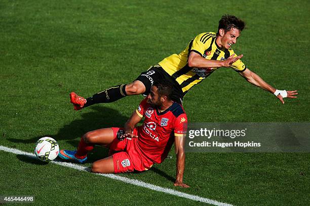 Alex Rodriguez of the Phoenix and Tarek Elrich of Adelaide United collide in a challenge during the round 20 A-League match between the Wellington...