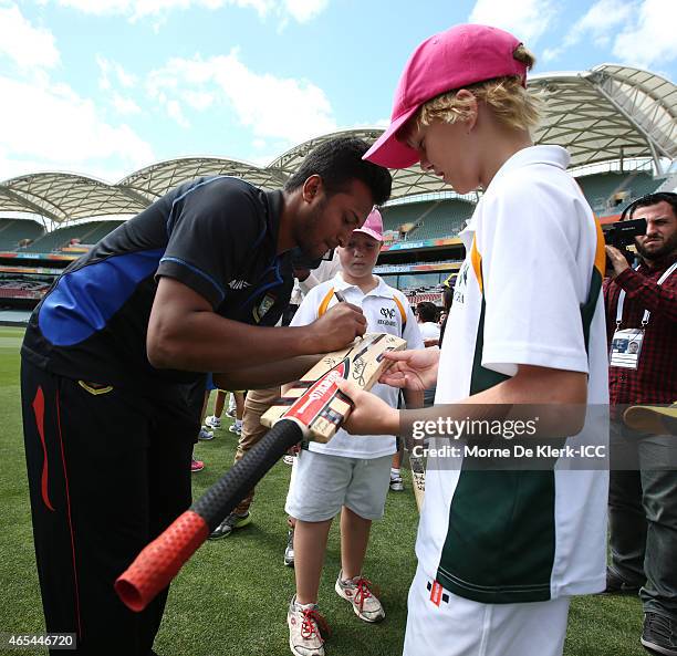 Shakib Al Hasan of Bangladesh signs a bat after taking part in the ICC Charity Coaching Clinic with the Woodville Rechabite Cricket Club at the...