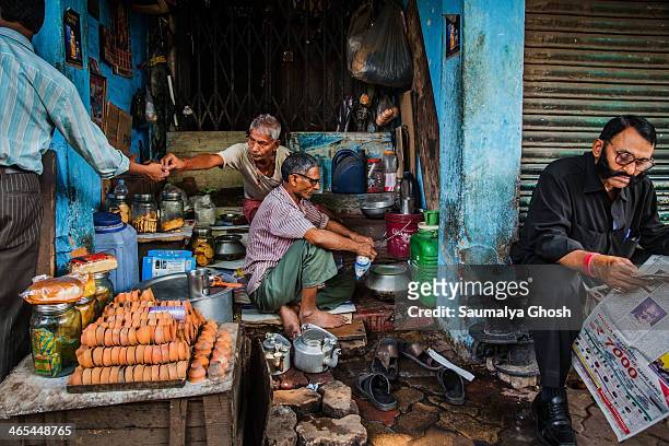 People are busy working at a Roadside tea stall in Kolkata