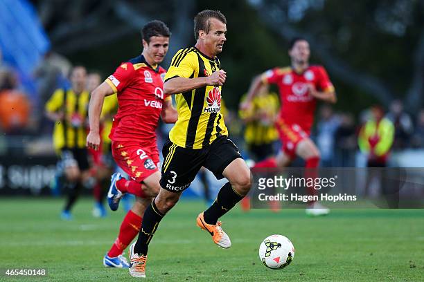 Joel Griffiths of the Phoenix beats the challenge of Michael Marrone of Adelaide United during the round 20 A-League match between the Wellington...