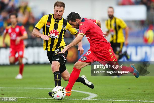 Sergio Cirio of Adelaide United is challenged by Ben Sigmund of the Phoenix during the round 20 A-League match between the Wellington Phoenix and...