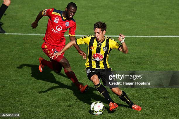 Alex Rodriguez of the Phoenix evades the defence of Bruce Djite of Adelaide United during the round 20 A-League match between the Wellington Phoenix...