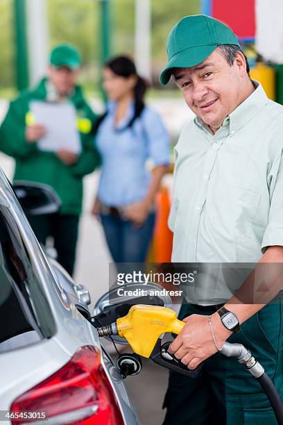 man putting fuel in the car - gas station attendant stock pictures, royalty-free photos & images