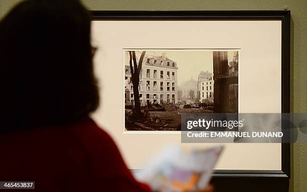 Visitor looks at a picture during a press preview for two exhibitions, "Charles Marville: A Photographer of Paris" and it's related show "Paris as...