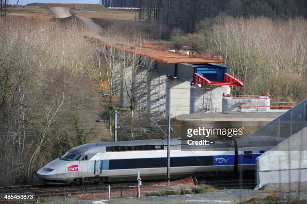 High speed TGV train passes by the two parts of a viaduct under construction, on January 27 in La Milesse, western France. The Viaduc de la Courbe...