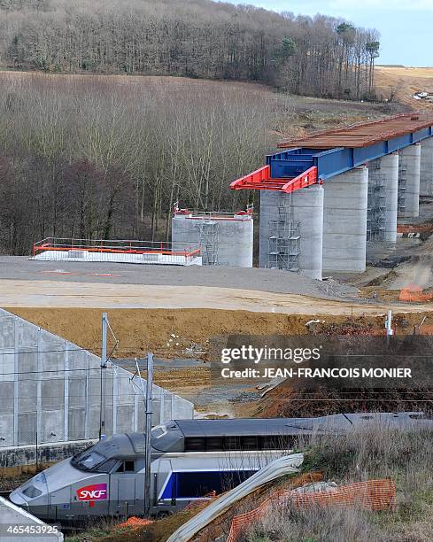 High speed TGV train passes by the two parts of a viaduct under construction, on January 27 in La Milesse, western France. The Viaduc de la Courbe...