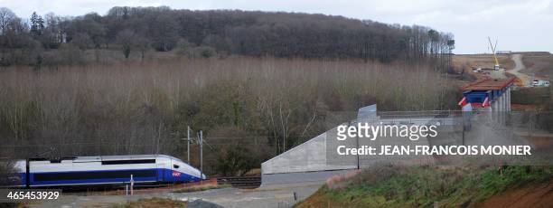 High speed TGV train passes by the two parts of a viaduct under construction, on January 27 in La Milesse, western France. The Viaduc de la Courbe...