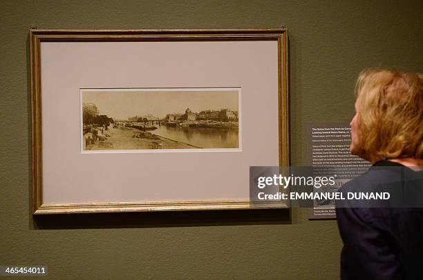 Visitor looks at a picture during a press preview two exhibitions, "Charles Marville: A Photographer of Paris" and it's related show "Paris as Muse:...