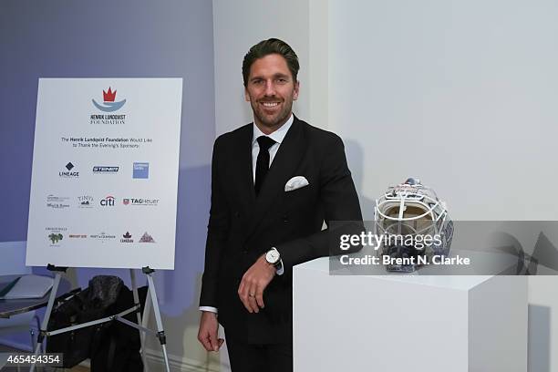 New York Rangers goaltender Henrik Lundqvist poses with one of his custom designed goalie masks during An Evening "Behind The Mask" With The Henrik...