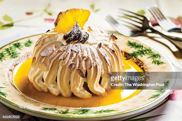 Baked Alaska at Le Viex Logis restaurant in Bethesda, MD. 2014. Baked Alaska dessert topped with pinapple and sauce.