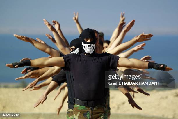 Fighters from the Iraqi Imam Ali Brigade, take part in a training exercise in Iraq's central city of Najaf on March 7 ahead of joining the military...
