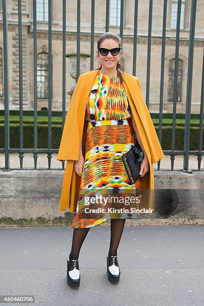 The Webster owner Laure Heriard Dubreuil wears a vintage Balenciaga coat, Celine dress and shoes and Italian Independent sunglasses on day 4 of Paris...