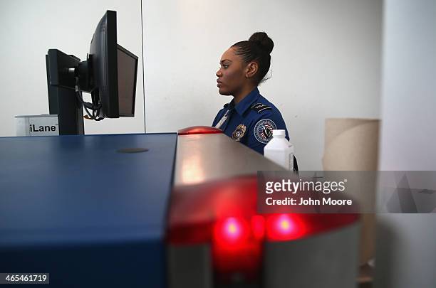 Agent watches xray monitors while screening luggage at a special TSA Pre-check lane at Terminal C of the LaGuardia Airport on January 27, 2014 in New...