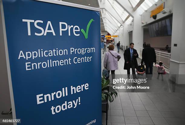 Travelers walk past a newly-opened TSA Pre-check application center at Terminal C of the LaGuardia Airport on January 27, 2014 in New York City. Once...